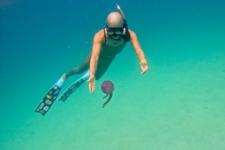 a woman jumping into the water